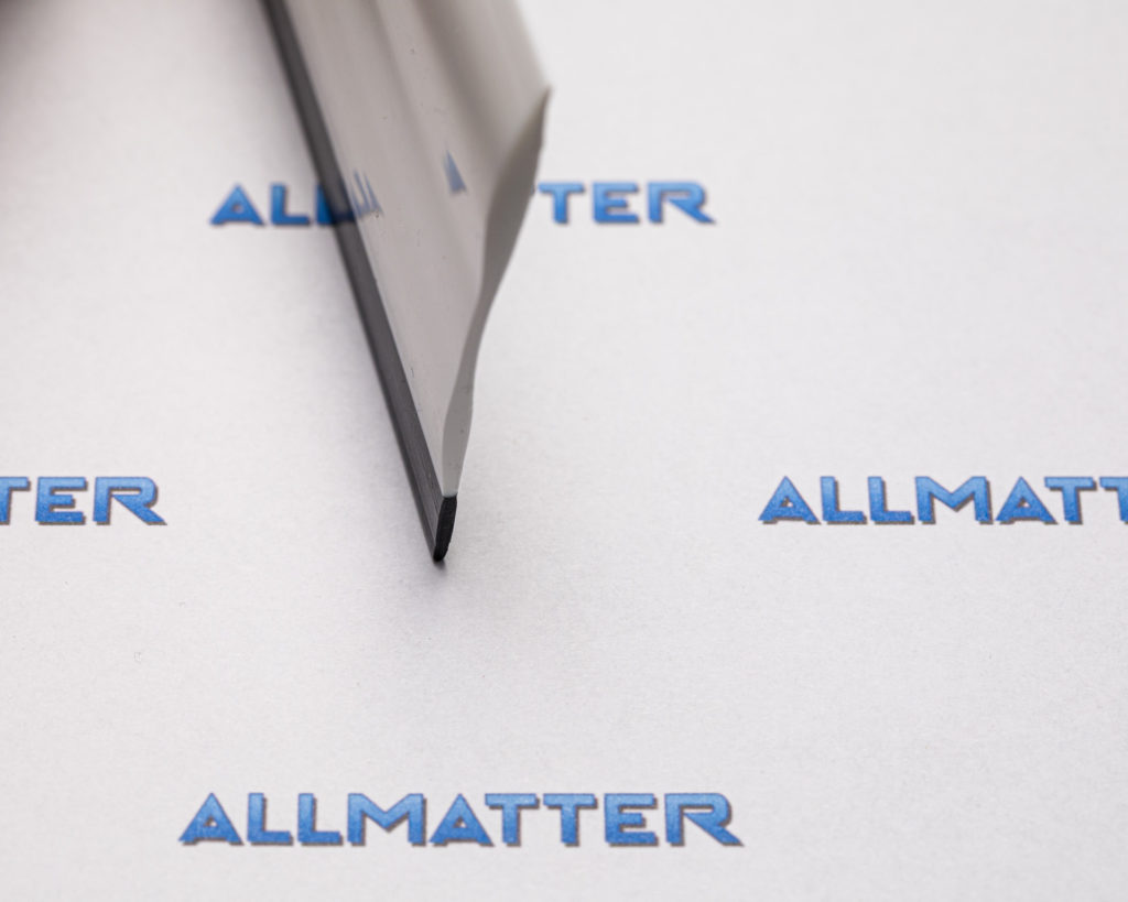 Ostrze narzędzia na tle papieru z napisem Allmatter